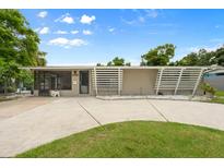 Charming single-story home featuring a minimalist front yard and modern architectural details at 2015 Bayshore Gardens Pkwy, Bradenton, FL 34207