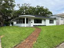 Charming one-story home featuring a brick walkway and lush, green lawn at 2333 22Nd S St, St Petersburg, FL 33712