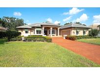 Stunning one-story home featuring a lush front yard and a red brick driveway at 2901 Little Country Rd, Parrish, FL 34219
