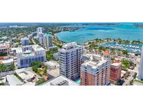 Stunning aerial view of the modern high-rise condo with waterfront views and downtown cityscape at 33 S Palm Ave # 1101, Sarasota, FL 34236