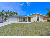 Charming single Gathering home featuring a well-manicured lawn and attached two car garage at 3417 49Th W St, Bradenton, FL 34209