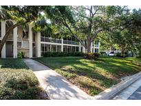 Condo building featuring lush landscaping and charming screened-in patios at 3745 Almeria Ave # 7S, Sarasota, FL 34239