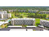 Scenic aerial view of the condo complex, showcasing the meticulously landscaped grounds and golf course at 3820 Ironwood Ln # 104-I, Bradenton, FL 34209