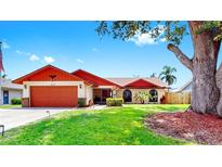 Charming single-story home with a well-manicured lawn, two-car garage, and colorful front-door accent at 4637 31St E Ct, Bradenton, FL 34203