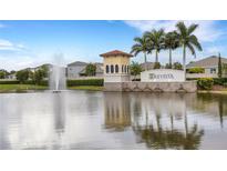 Community entrance with fountain and palm trees overlooking the 'Trevesta' sign on a sunny day at 5213 Patano Loop, Palmetto, FL 34221
