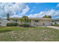 Charming single-story home with a well-maintained lawn, mature landscaping, and attached one car garage at 5412 Skyline Pl, Sarasota, FL 34232