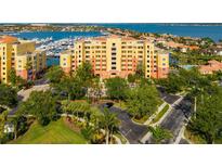 Beautiful waterfront building featuring lush landscaping and convenient parking at 610 Riviera Dunes Way # 503, Palmetto, FL 34221