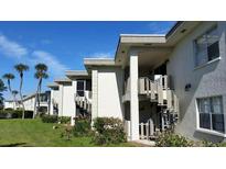 Low rise condominiums featuring stairwells and well-kept landscaping at 6300 Flotilla Dr # 108, Holmes Beach, FL 34217