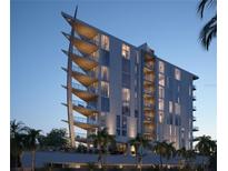 Modern condo building with unique architecture, private balconies and lush tropical landscaping at 688 Golden Gate Point # 201, Sarasota, FL 34236