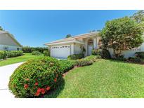 Charming one-story home with a well-manicured lawn and beautiful landscaping at 7023 Woodside Oaks Cir # 1, Sarasota, FL 34231