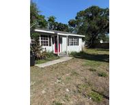 Charming single-story home with a bright red front door and a well-maintained lawn at 7109 28Th E St, Sarasota, FL 34243