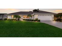 Charming single-story home with lush lawn, manicured landscaping, and a welcoming two-car garage at 7404 13Th Avenue W Dr, Bradenton, FL 34209