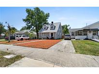 Charming two-story home with a gray exterior, manicured lawn, and a long driveway at 766 13Th S Ave, St Petersburg, FL 33701