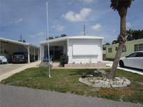 Charming single-story home featuring well-maintained landscaping and a cozy front porch area at 845 S Green Cir, Venice, FL 34285