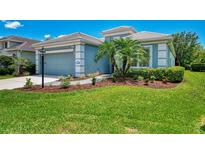 Charming home featuring a well-manicured lawn and lush landscaping, enhancing its curb appeal at 12229 Stuart Dr, Venice, FL 34293