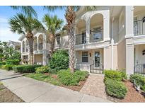 Townhouse exterior with lush landscaping, multiple balconies, and Mediterranean style architecture at 1519 Napoli E Dr, Sarasota, FL 34232
