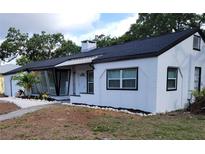 Charming single-story home showcasing a white exterior, complemented by a well-maintained yard and dark roof at 1802 19Th W Ave, Bradenton, FL 34205