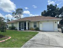 Charming single-story home featuring a well-maintained lawn, screened porch, and attached one-car garage at 4027 Allure Ln, North Port, FL 34287