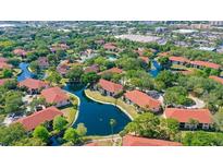 Scenic aerial view of a waterfront community with lush landscaping and multiple pools at 4325 46Th W Ave # 203, Bradenton, FL 34210