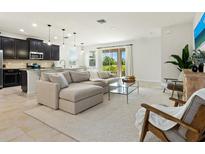 Open-concept living area featuring a comfortable sectional sofa and abundant natural light at 4615 73Rd E St, Bradenton, FL 34203