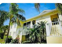 Charming condo with lush landscaping, including palm trees and well-maintained gardens in a desirable community at 600 Mirabella Cir # 201, Venice, FL 34292