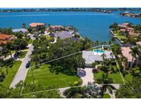 Waterfront estate with lush landscaping, a private pool, and stunning views of the bay at 7614 Peninsular Dr, Sarasota, FL 34231
