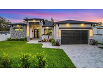 Stunning modern home showcasing stone accents, professional landscaping, and a freshly sealed driveway at 805 Padua Ct, Nokomis, FL 34275