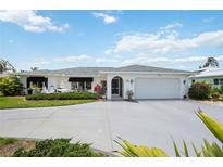 Charming single-story home featuring a well-maintained yard and an attached two-car garage at 965 E Gondola Dr, Venice, FL 34293