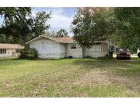 Quaint single-story home with a yard and mature trees at 104 22Nd Street E Ct, Bradenton, FL 34208