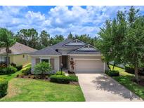 Charming single-story home with a well-manicured lawn and lush landscaping at 11794 Forest Park Cir, Bradenton, FL 34211