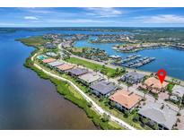 Breathtaking aerial view of waterfront homes, marina, and lush landscapes in a desirable coastal community at 1241 Riverscape St # B, Bradenton, FL 34208