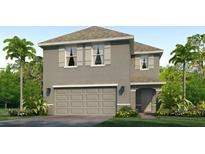 Charming two-story home boasts a neutral color, two-car garage, and lush tropical landscaping at 17357 Whiskey Creek Trl, Parrish, FL 34219