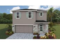 Charming two-story home featuring stone accents, a two-car garage, and a neatly landscaped front yard at 1906 Cobb Trl, Parrish, FL 34219