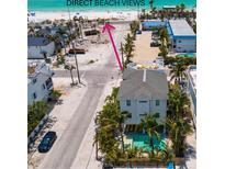 Beautiful beach house with lush landscaping and a private pool, just steps away from the white sandy beach at 2201 Avenue C, Bradenton Beach, FL 34217