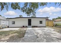 Charming single-story home featuring a black front door, white siding and minimal landscaping at 2652 26Th St, Sarasota, FL 34234
