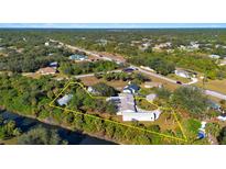 Beautiful aerial view of the property with surrounding foliage and access to the canal and waterfront at 31 Twig Ct, Port Charlotte, FL 33954