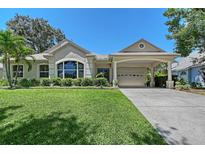 Charming single-story home with a well-manicured lawn, porte-cochère and lush landscaping at 4603 4Th E Ave, Bradenton, FL 34208