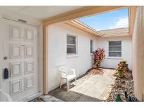 Front door leads to a bright entryway with courtyard, adding charm and natural light at 5062 White Oak Ct, Bradenton, FL 34207