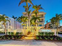 Beautiful building exterior with lush landscaping and palm trees, perfect for a relaxed lifestyle at 6512 Midnight Pass Rd # 301, Sarasota, FL 34242