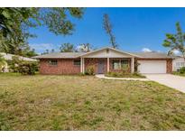 Charming single-story brick home with a well-maintained lawn and an attached two-car garage at 7803 2Nd W Ave, Bradenton, FL 34209