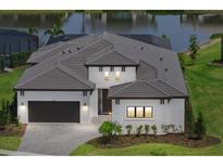 Beautiful one-story home featuring a well-manicured lawn, tile roof, and a two-car garage at 8982 Baroque Ter, Sarasota, FL 34240