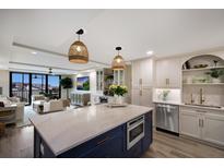 Bright, open kitchen with a center island and modern appliances, adjacent to an airy living space at 2045 Gulf Of Mexico Dr # M1-505, Longboat Key, FL 34228
