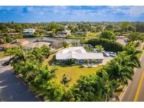 Waterfront property with beautiful landscaping, complemented by a stunning home exterior and boat dock at 2159 Constitution Blvd, Sarasota, FL 34231