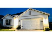 Charming single-story home featuring a two-car garage and meticulously maintained landscaping at 2410 Mizner Bay Ave, Bradenton, FL 34208