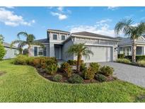 Charming one-story home with a well-manicured lawn, lush landscaping, and a brick paver driveway with great curb appeal at 2794 Butterfly Jasmine Trl, Sarasota, FL 34240