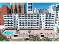 Apartment complex with a pool and an entrance with a bricked drive and mature landscaping at 33 S Gulfstream Ave # 306, Sarasota, FL 34236