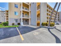 Multi-story condo building with assigned parking space, well-maintained landscaping, and private balconies overlooking the property at 3521 Lake Bayshore Dr # 3521, Bradenton, FL 34205