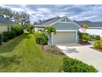 Charming single-story home featuring a well-manicured lawn and an attached two-car garage at 3631 Shimmering Oaks Dr, Parrish, FL 34219