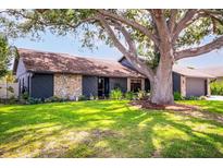 Charming single-story home featuring stone accents, fresh landscaping and a large shade tree at 4612 Masefield Pl, Sarasota, FL 34241