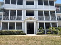 Three-story condo building featuring screened-in porches and well-maintained landscaping at 4802 51St W St # 1724, Bradenton, FL 34210